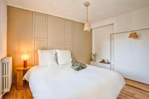a white bedroom with a large white bed at Le Chéron - Confort, Wi-Fi & commerces à deux pas in Caen