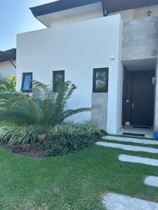 a house with a plant in the front yard at Ideal home to relax and enjoy with family in El Nance +18 photos
