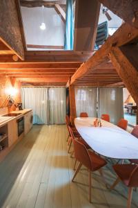 a kitchen with a table and chairs in a room at Gîte insolite in Nuits-Saint-Georges