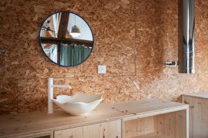 a bathroom with a sink and a mirror at Gîte insolite in Nuits-Saint-Georges