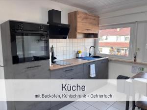 a kitchen with a sink and a stove at Casa Viola Filderstadt, 2 Zimmer, komplett renoviert, top für Familien und Geschäftsreisen, super ausgestattet, PKW Stellplatz in Filderstadt
