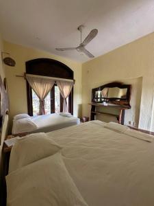 Ένα ή περισσότερα κρεβάτια σε δωμάτιο στο Casa Nhisdao