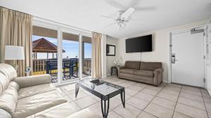 a living room with a couch and a table at Romar Tower 1B in Orange Beach