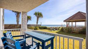a blue table and chairs on a balcony with the beach at Romar Tower 1B in Orange Beach