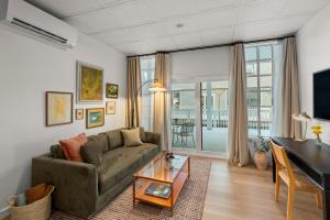 a living room with a couch and a table at The Optimist Guesthouse | 3 in Camden