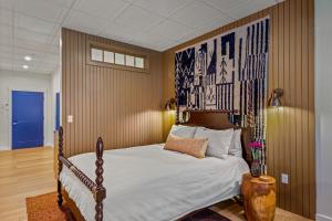 a bedroom with a bed with a poster on the wall at The Optimist Guesthouse | 3 in Camden