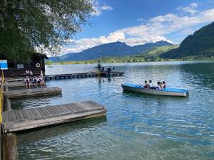 a group of people in a boat on a lake at Sissy Appartment in Kössen