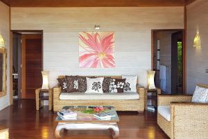 a living room with a couch and a table at Villa Tea Tea in Papetoai
