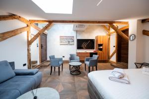 a room with a bed and a couch and a table at Stella Di Notte City Center Studios in Belgrade