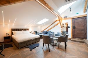 a bedroom with a bed and a table and chairs at Stella Di Notte City Center Studios in Belgrade