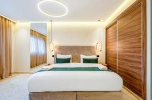 a bedroom with a large white bed with a large mirror at Stay tanger in Tangier
