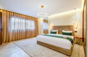 a bedroom with a large bed and a large window at Stay tanger in Tangier