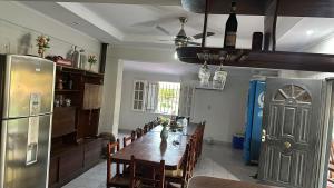 a dining room with a table and a refrigerator at Casa quinta in La Banda
