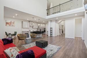 ein Wohnzimmer mit einem roten Sofa und einer Küche in der Unterkunft Near Lake Conroe • Private Yard • Pet Friendly in Keenan