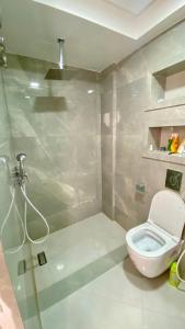 a bathroom with a white toilet and a shower at Imsouane Sea surf Camp in Imsouane +54 photos