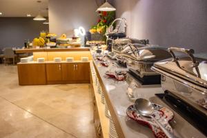 a kitchen with a counter with utensils on it at Sonesta Hotel Cali in Cali