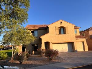 a large brick house with a garage at West Phoenix Mini Master Bennet in Phoenix +2 photos