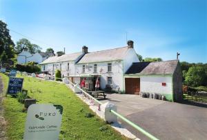 a white building with a sign in front of it at 2 Bed in Llanmadoc oc-hh2110 in Llanmadoc
