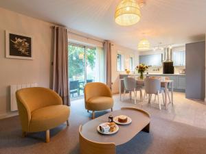 a living room with a table and chairs and a kitchen at 2 Bed in Saltash oc-87713 in St. Mellion