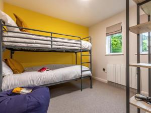 two bunk beds in a room with a yellow wall at 2 Bed in Saltash oc-87713 in St. Mellion +12 photos