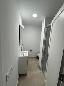 a bathroom with a toilet and a sink and a mirror at La posada del sur in San Bartolomé de Tirajana