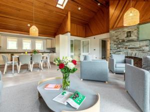 a living room with a vase of flowers on a table at 3 Bed in Saltash oc-87717 in St. Mellion