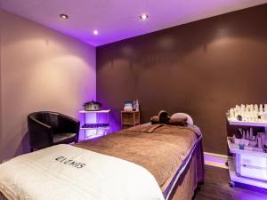 a room with a bed with purple lights on it at 3 Bed in Saltash oc-87717 in St. Mellion