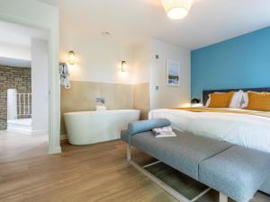 a bedroom with a large bed and a bath tub at 2 Bed in Saltash oc-87707 in St. Mellion +18 photos