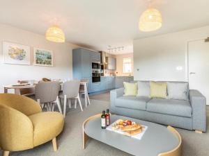 a living room with a couch and a table at 2 Bed in Saltash oc-87712 in St. Mellion