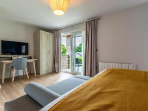 a bedroom with a bed and a tv and a desk at 2 Bed in Saltash oc-87712 in St. Mellion +14 photos