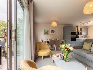a living room with a couch and a table at 2 Bed in Saltash oc-87703 in St. Mellion