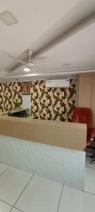 an office with a reception desk with a wall of wine bottles at Hotel Nest View In in Ahmedabad