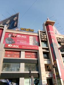 a building with signs on the side of it at Hotel Nest View In in Ahmedabad