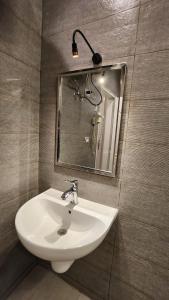 a bathroom with a sink and a mirror at Kemet Apartment luxor in Luxor +6 photos