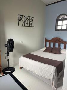 En eller flere senge i et værelse på Raízes Pousada