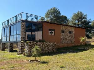 a house with a balcony on top of it at Cábaña bonita vista in Atemajac de Brizuela