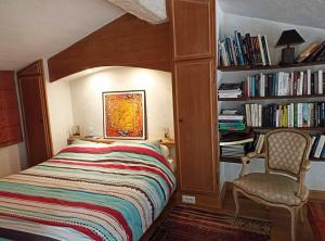 a bedroom with a bed and a book shelf with books at Paradis bleu in Agay - Saint Raphael +23 photos