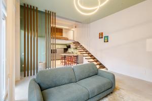a living room with a couch and a staircase at Living Calabriando in Reggio di Calabria