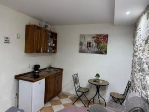 een keuken met een tafel en een kleine tafel en stoelen bij Little bay apart 2 in Kotor