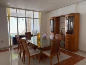 a dining room with a glass table and chairs at Casa Vemisa Puerto Escondido in Puerto Escondido