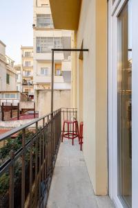 a balcony with a table and chairs on it at Living Calabriando in Reggio di Calabria