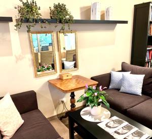 a living room with two couches and a table at Hotel Braunsbergerhof in Lana