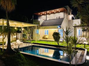 a house with a swimming pool in front of it at Paradise Pool by StayJadePoolGarden30min E-city in Hosūr