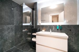 a bathroom with a white sink and a mirror at New Modern Home-Projector-Nespresso-View-Balcony in Komárov