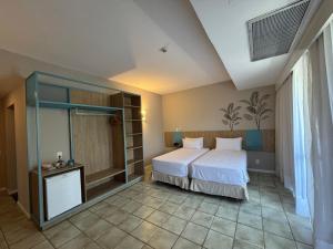 een slaapkamer met een groot bed en een glazen kast bij Hotel Camarote Salvador in Salvador