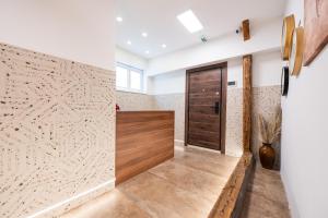 a hallway with a wooden door and a wall at Stella Di Notte City Center Studios in Belgrade +50 photos