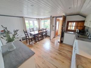 a kitchen and dining room with a table and chairs at Le Châlet de l'Authie in Vitz-sur-Authie