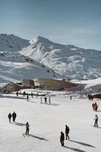 a group of people skiing on a snow covered mountain at Le Fitz Roy, a Beaumier hotel in Val Thorens +100 photos
