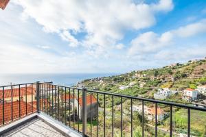 a balcony with a view of the ocean at Casa da Feira - Located in a peaceful Calheta area with sea views in Calheta
