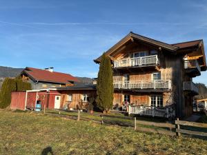a large wooden house on a hill with a yard at Sissy Appartment in Kössen